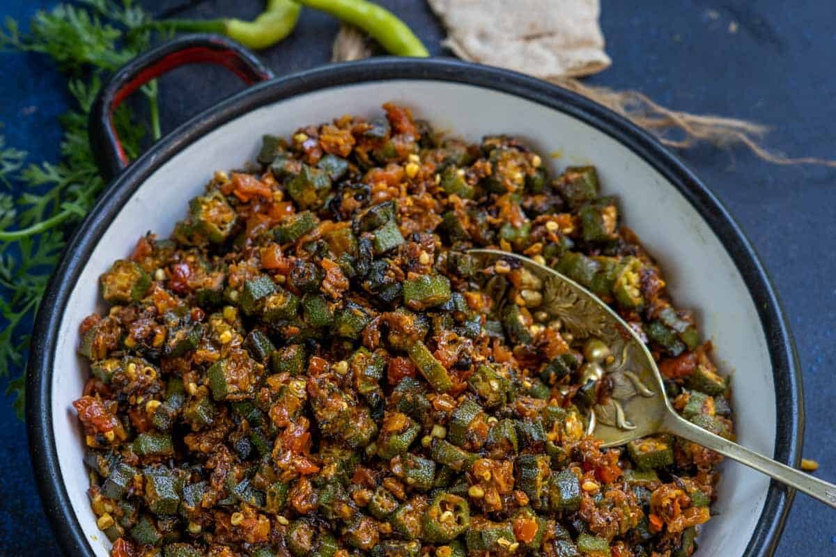 Spiced green peas cooked with tomatoes and herbs in a bowl.