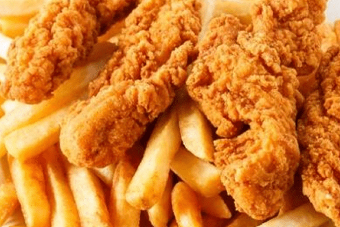 Golden fried chicken tenders with crispy French fries.