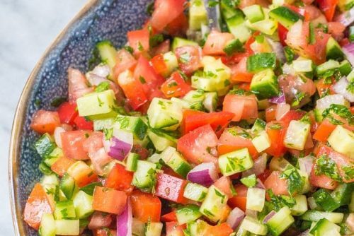 A colorful bowl of fresh diced vegetable salad.