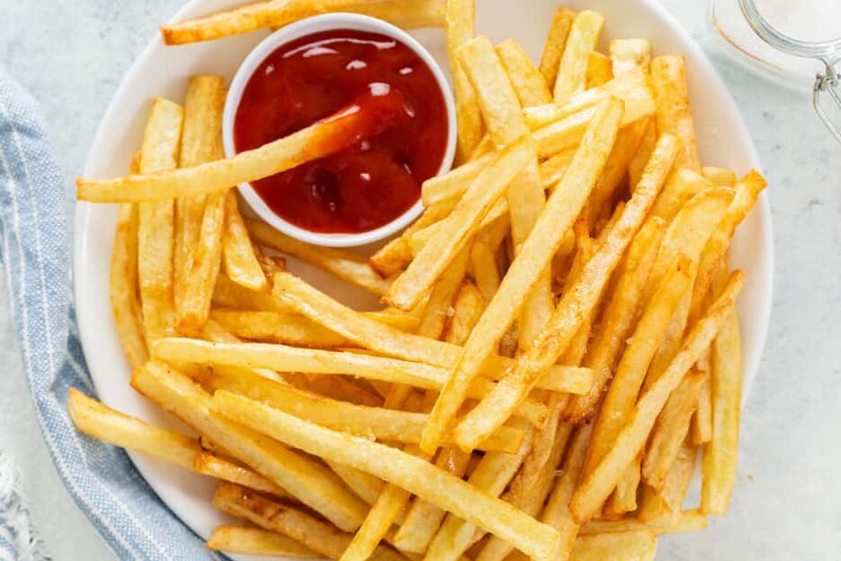 Crispy golden French fries with a side of ketchup.