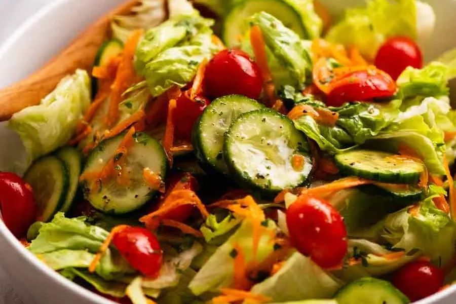 Fresh mixed salad with cucumbers, cherry tomatoes, and lettuce.
