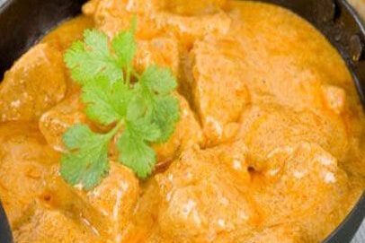 Creamy butter chicken garnished with cilantro.