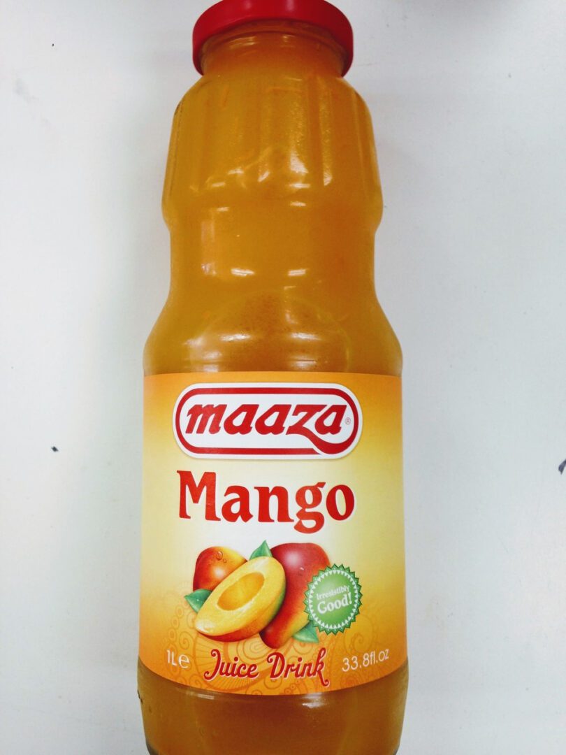 A bottle of Maaza mango drink with fresh mangoes on the label.