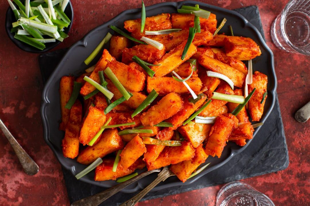 Spicy chicken wings garnished with fresh green onions.
