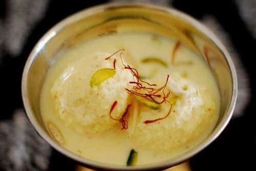 Traditional Indian ras malai dessert garnished with saffron strands.