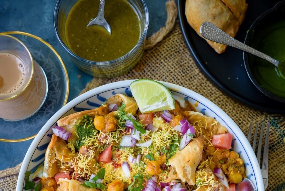 A vibrant plate of loaded nachos topped with cheese, jalapeños, and lime.