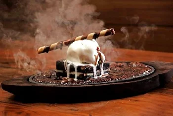 Melting ice cream with a chocolate stick on a hot skillet.