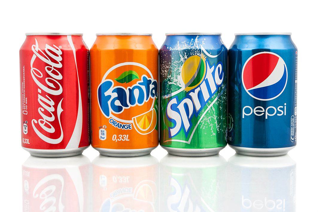 Four soda cans: Coca-Cola, Fanta, Sprite, and Pepsi in a row.