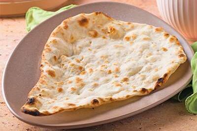 A plate with a piece of flatbread.