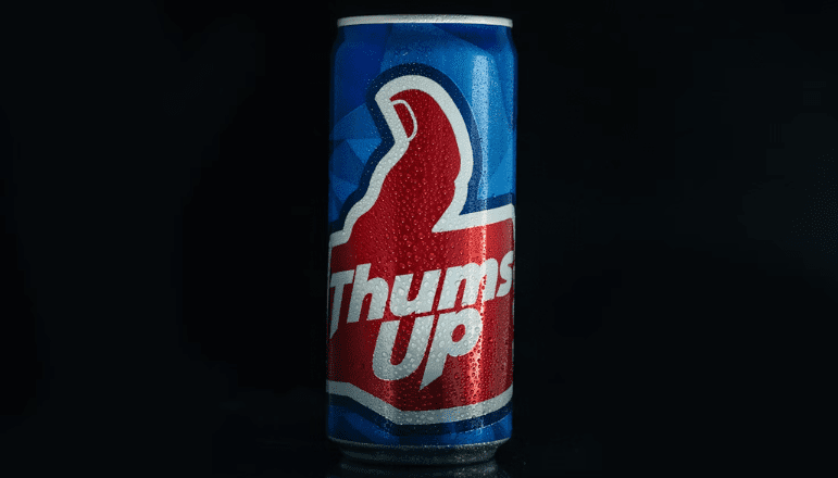 A blue can of Thums Up soda with a red thumbs-up logo.
