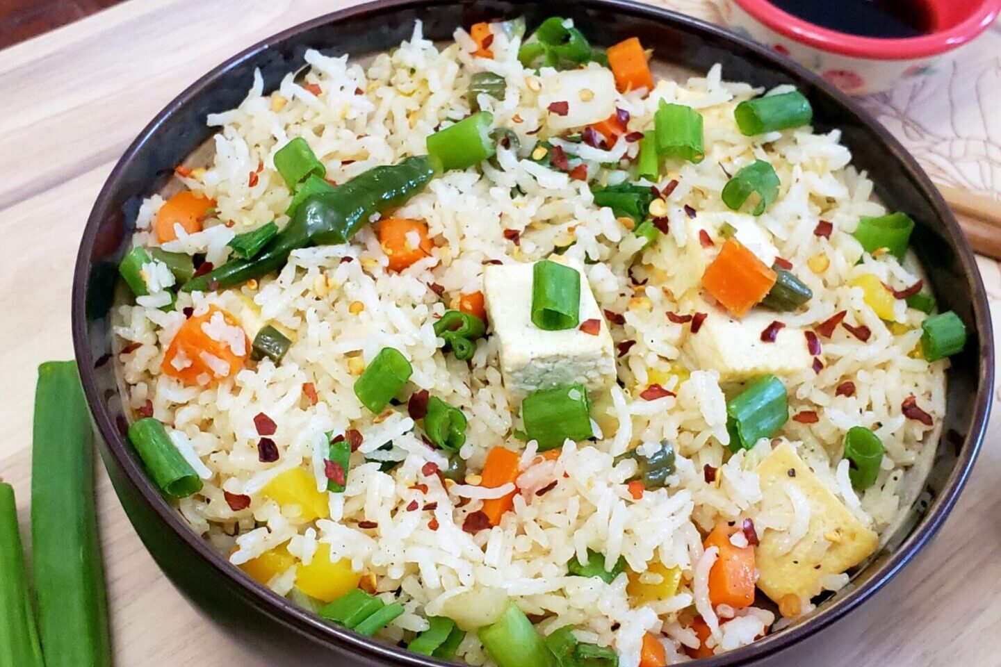 Colorful vegetable fried rice with green onions and bell peppers.